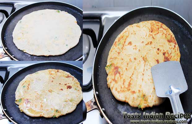 Place paratha on hot tawa. Drizzle oil and cook it on medium flame