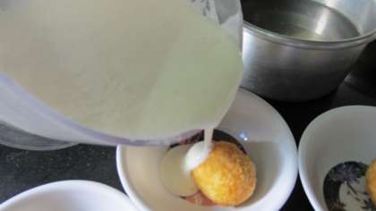 pour the beaten curd over each vada