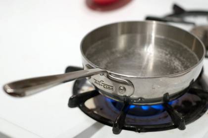 Water on stove top in a pan