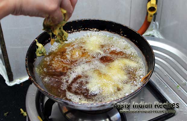 Spread Pakora Batter in Hot Oil