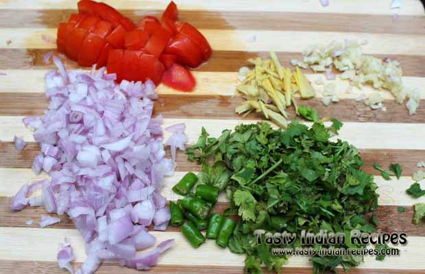 Chop onion, tomato, ginger, garlic, green chillies and coriander leaves finely. Also make some ginger julienne