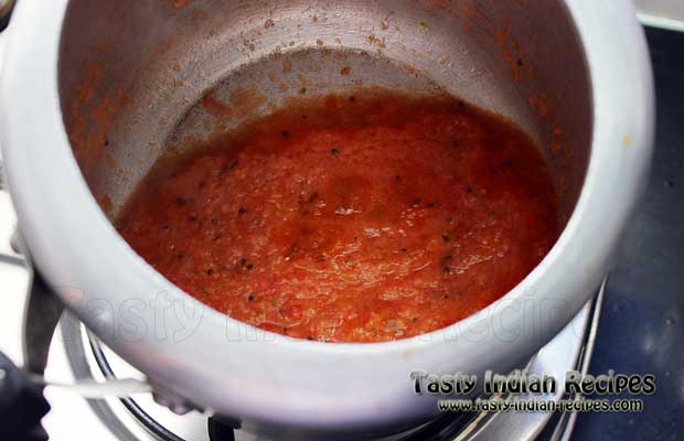 Heat oil in a pressure cooker and allow the seeds to pop up. Once the seeds stop crackling, then add prepared tomato pu